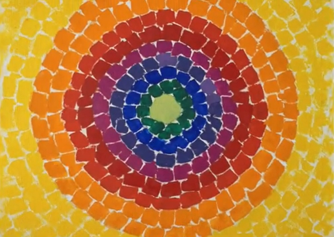 A series of concentric circles made wiht squares of ripped paper. each circle is a single color, with yellow at the outside, then orange, red, purple, blue, and green.