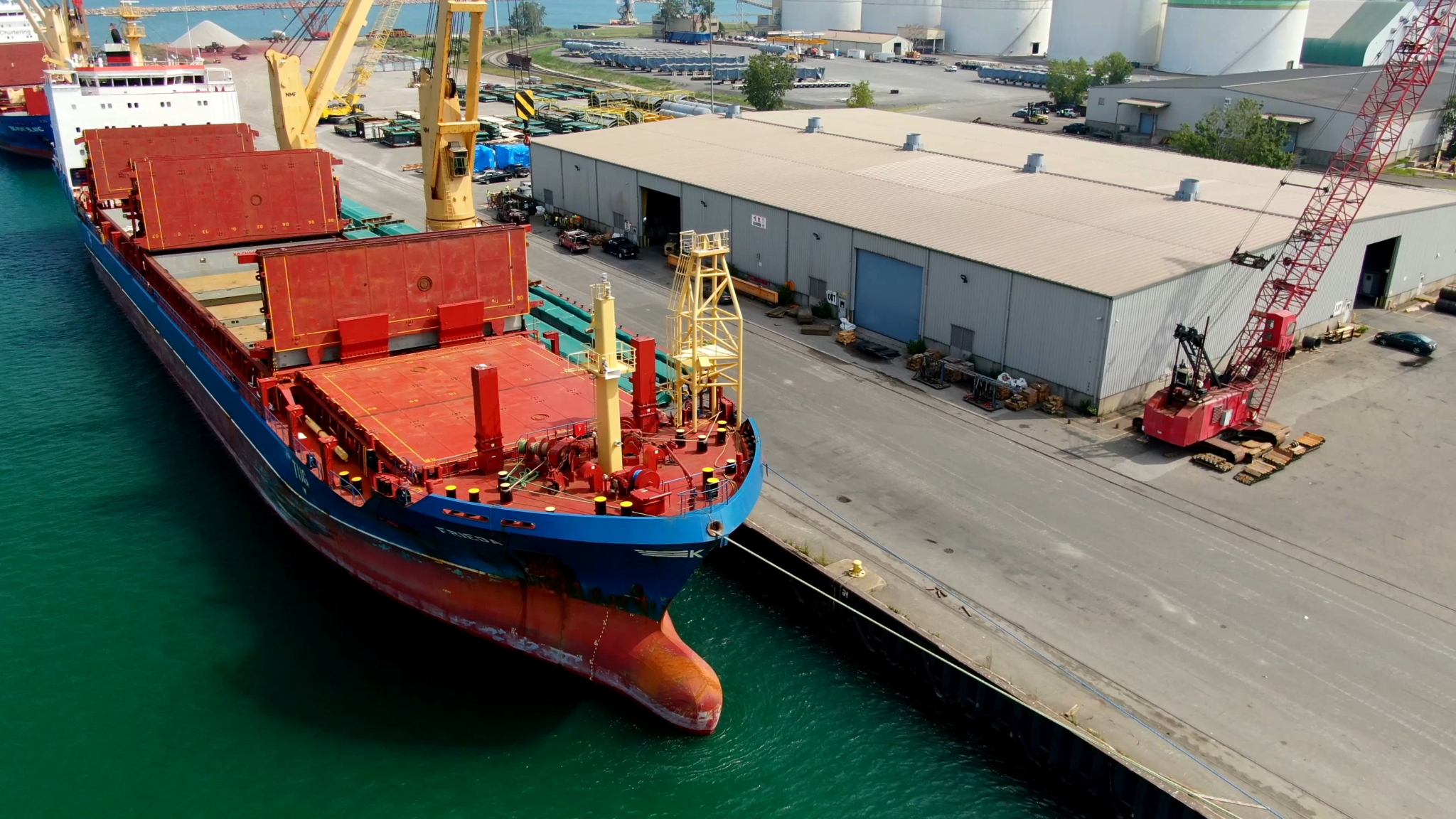 A shipping boat docked at a supply station