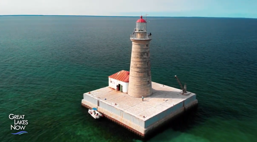 A lighthouse on a small, man-made island surrounded by water