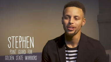 Stephen Curry talking to the camera. This screenshot was taken as he is mid blink.